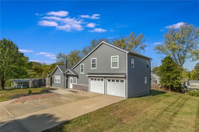 View of property with a front lawn and a garage | Image 2