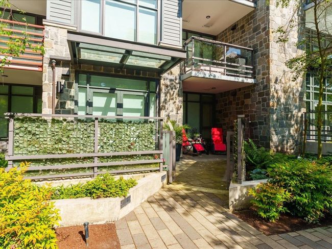 View of exterior entry with a patio and stone siding | Image 28