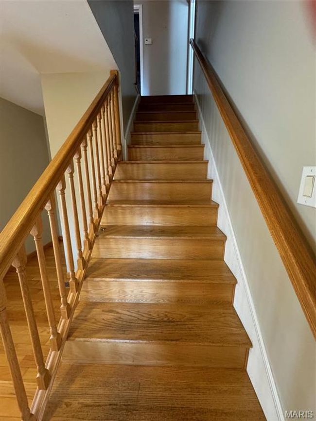 Stairway featuring hardwood / wood-style flooring | Image 18