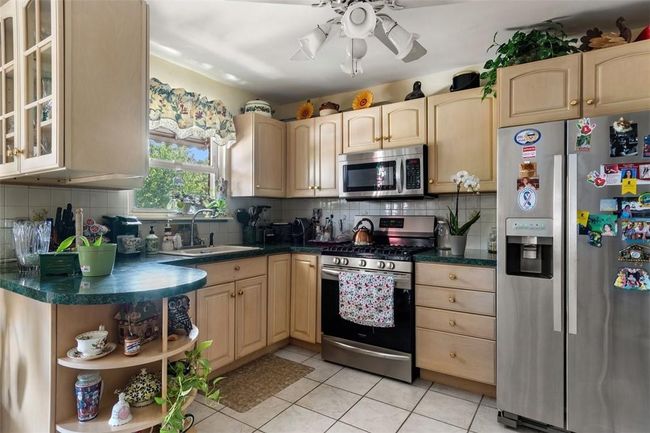 Kitchen with appliances with stainless steel finishes, sink, tasteful backsplash, and ceiling fan | Image 6