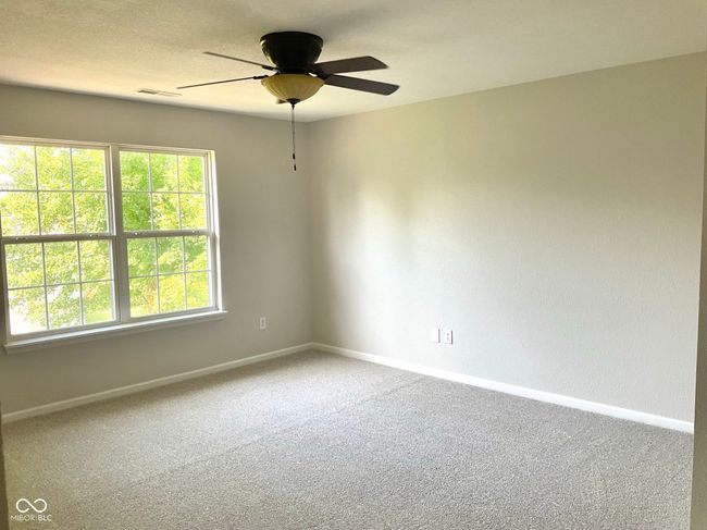 Spacious primary bedroom with new paint and carpeting | Image 20