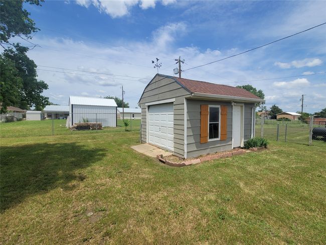 Separate Backyard Garage with garage door, window and entry door. Perfect for workshop, ATVs and extra storage. | Image 26