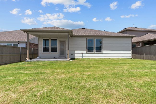 Rear view of property featuring a patio, a fenced backyard, and roof with shingles | Image 26