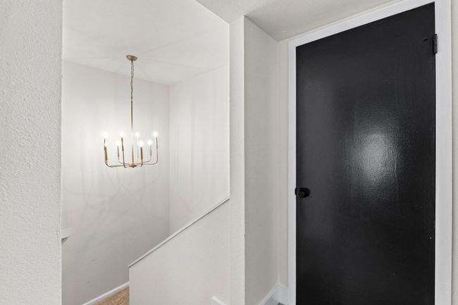 Corridor featuring a chandelier and baseboards | Image 16