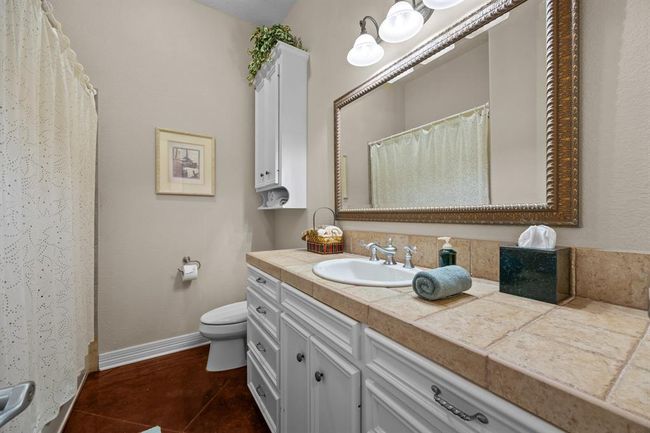 Tile-topped vanity with inset sink, large vanity maximizes style and function. | Image 9