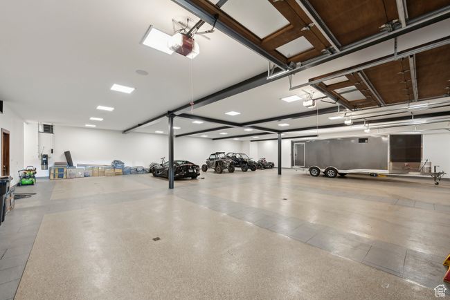 Garage featuring a garage door opener and recessed lighting | Image 39