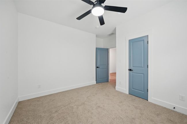 Unfurnished bedroom with carpet floors, baseboards, ceiling fan, and visible vents | Image 12