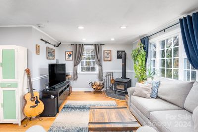 Charming living room with woodstove and beautiful natural light, especially in the morning! | Image 3