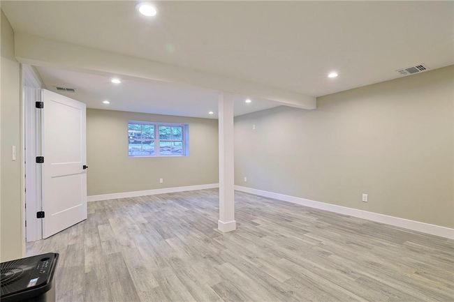 Basement with light hardwood / wood-style floors | Image 21