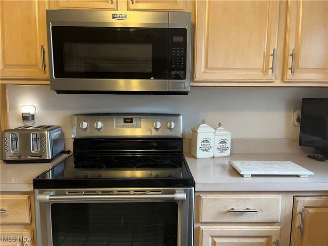 Kitchen with stainless steel appliances - Electric Stove and Microwave (2024) | Image 14