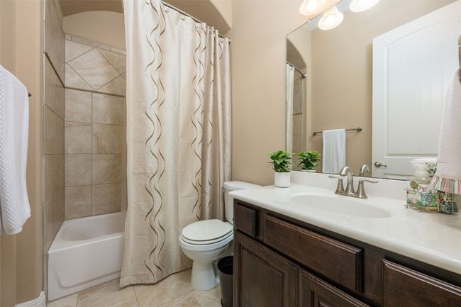 Bathroom featuring vanity, tile patterned flooring, and shower / tub combo | Image 8