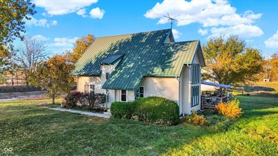 Front entry, featuring the metal roof | Image 1