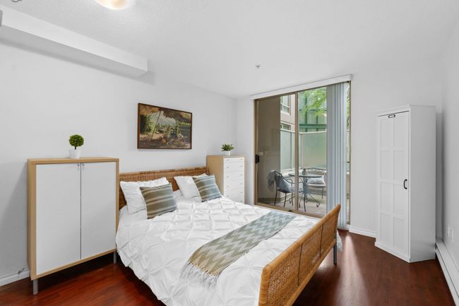 Bedroom featuring access to outside, wood finished floors, and baseboards | Image 10