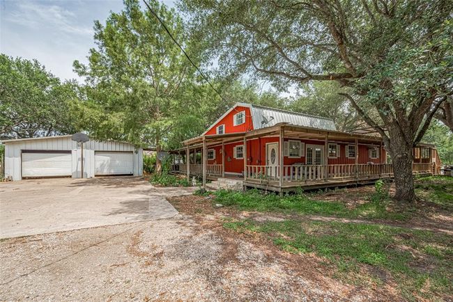 Extended driveway with 2 oversized bays for large trucks and farm equipment, with room for a shop. | Image 5