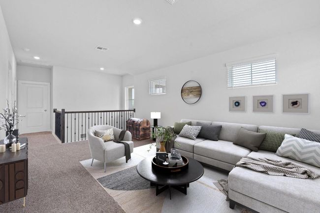Carpeted living area with recessed lighting, visible vents, and plenty of natural light | Image 18