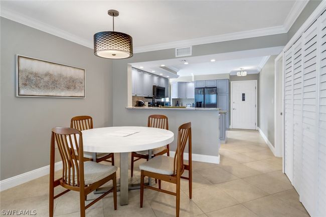 Dining room featuring light tile patterned flooring and ornamental molding | Image 11