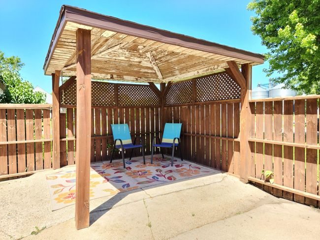 The covered patio at junction of fence is perfect for entertaining or relaxing. | Image 19