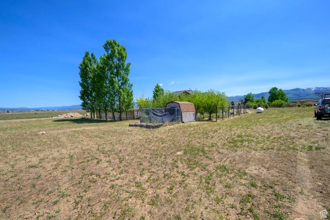 View of yard with an outbuilding, a mountain view, and a rural view | Image 38