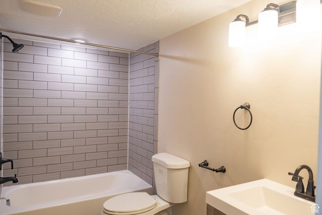 Full bath with shower combination, a textured ceiling, and vanity | Image 29