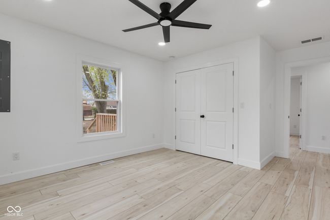 unfurnished bedroom with a closet, baseboards, recessed lighting, visible vents, and wood finished floors | Image 49