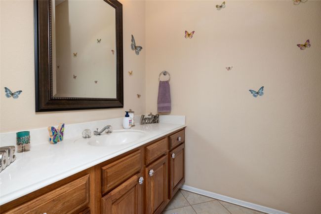 Bathroom featuring baseboards, vanity, and tile patterned flooring | Image 27
