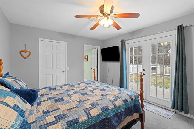 Primary bedroom has french doors leasing to a fenced in area. | Image 8