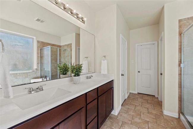 Dual sinks ensure both partners have a dedicated area for grooming and self-care! Ample counter space is only enhanced by the tremendous space beneath, which includes multiple drawers of varying sizes and base storage cabinetry! | Image 14