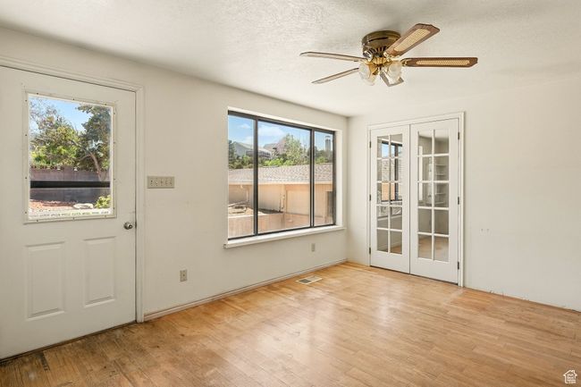 Foyer with french doors, wood finished floors, ceiling fan, and a textured ceiling | Image 17