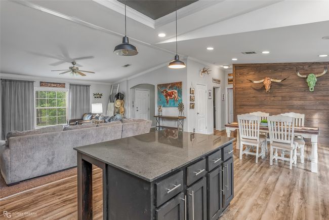 Kitchen featuring light wood-type flooring, arched walkways, and crown molding | Image 23