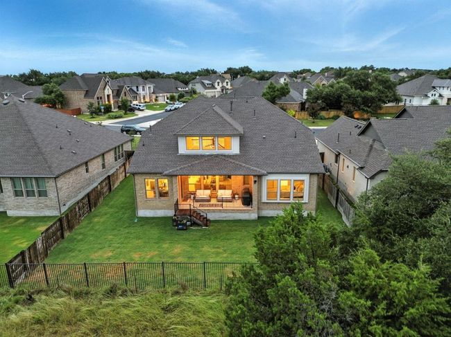 Rear view of house featuring a residential view, a fenced backyard, and roof with shingles | Image 37