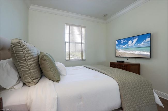 Bedroom featuring ornamental molding and wood finished floors | Image 18