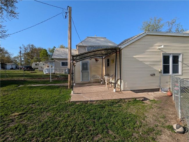 Rear view of property featuring fence, a lawn, and a patio | Image 7