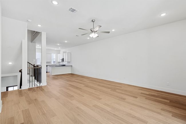 Unfurnished living room with light hardwood / wood-style flooring and ceiling fan | Image 15