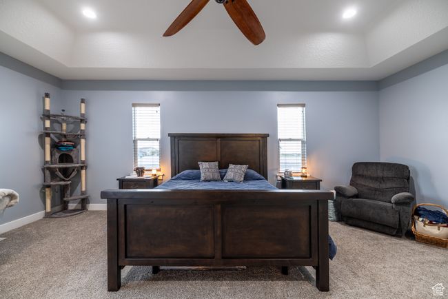 Bedroom featuring light colored carpet and ceiling fan | Image 27