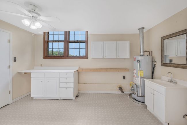 ANOTHER VIEW OF LAUNDRY WITH SINK, CABINETS, AND FOLDING AREA. | Image 28