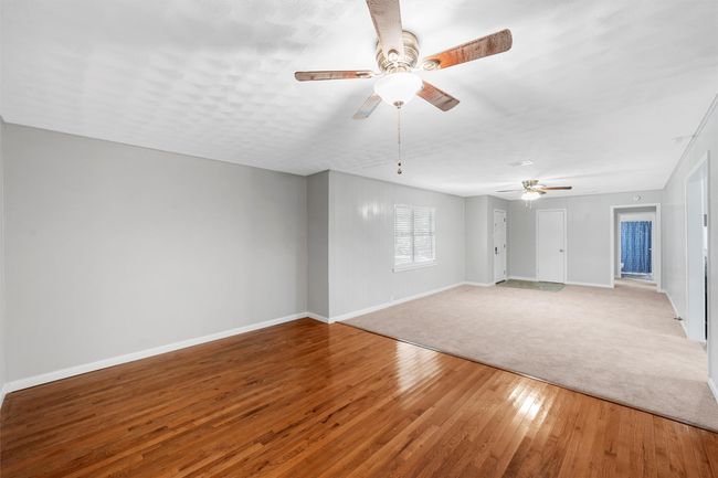 Unfurnished living room featuring ceiling fan and light wood-type flooring | Image 5