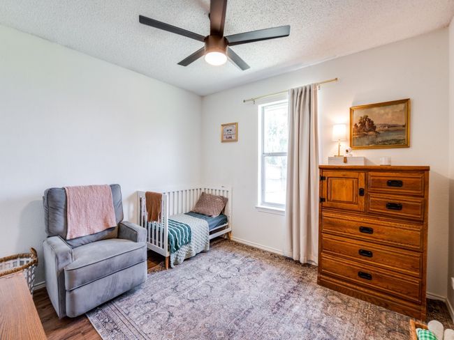 Bedroom with a textured ceiling and a ceiling fan | Image 15