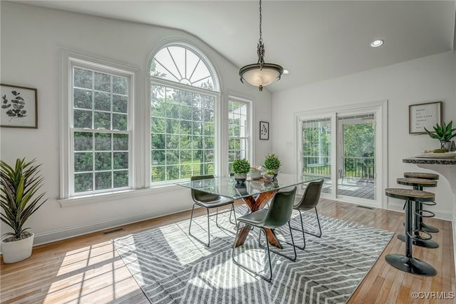 Bright morning room with panoramic backyard views opens to a beautifully landscaped yard and screened-in porch—perfect for seamless indoor-outdoor living. | Image 27