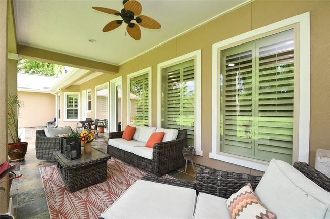 Relax on your warm Missouri City evenings, cooled by the shaded covered patio and the stylish outdoor ceiling fans. | Image 44