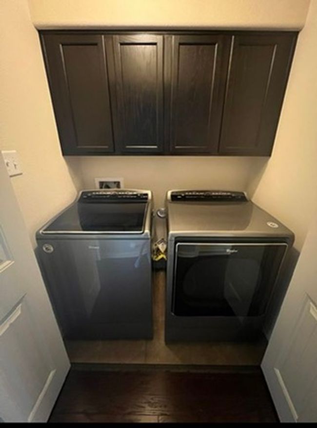 Washroom featuring washing machine and clothes dryer and cabinet space | Image 16