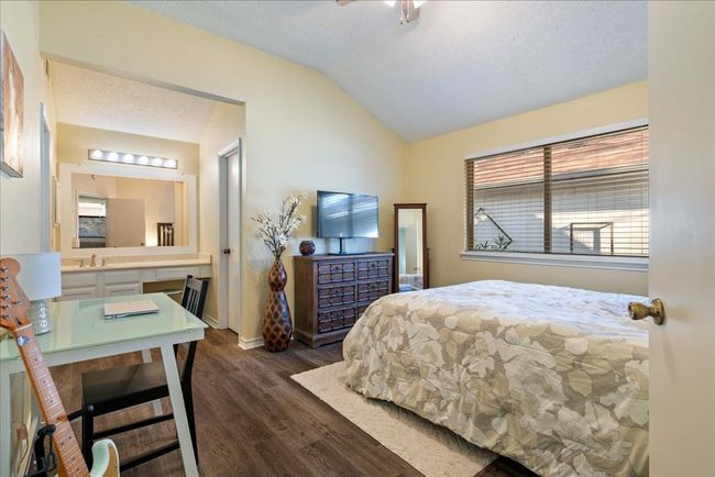 Primary bedroom featuring lofted ceiling, ensuite 1/4 bath, LVP floors | Image 14