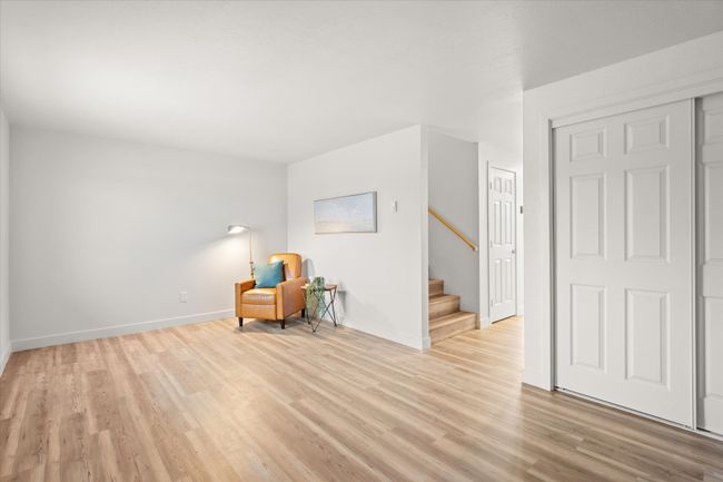 Unfurnished room featuring stairs and light wood-style flooring | Image 4