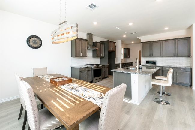 Dining room with light wood-style floors and recessed lighting | Image 6