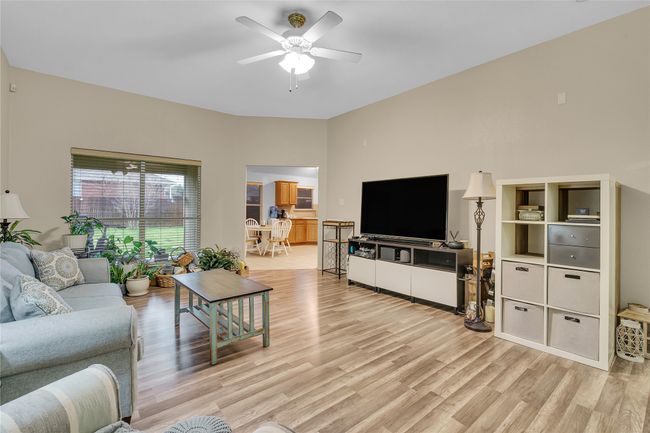Living room featuring light wood-style flooring and a ceiling fan | Image 7