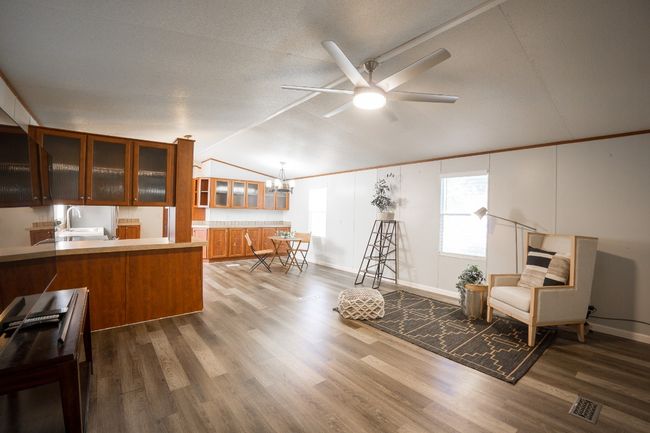 Sitting room featuring lofted ceiling, ceiling fan, wood finished floors, and a chandelier | Image 13