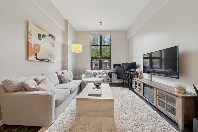 The beautiful living area is breathtaking with a huge window that lets in so much natural light. | Image 4