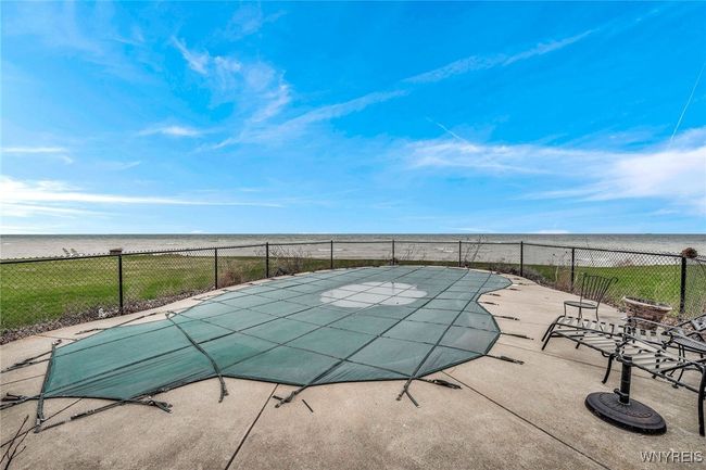 Inground pool sits between house and lake for spectacular views | Image 10