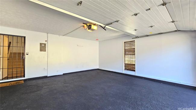 Enclosed garage with new flooring. | Image 23