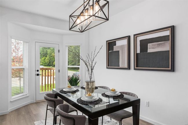 Dining room featuring a notable chandelier and hardwood / wood-style floors | Image 12