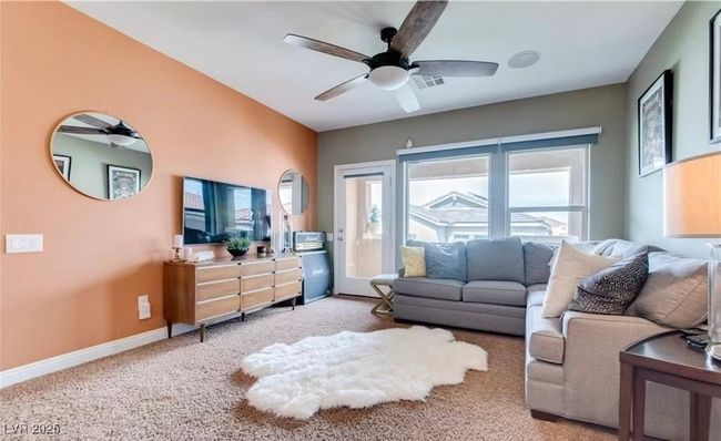 Carpeted living room featuring ceiling fan and baseboards | Image 7